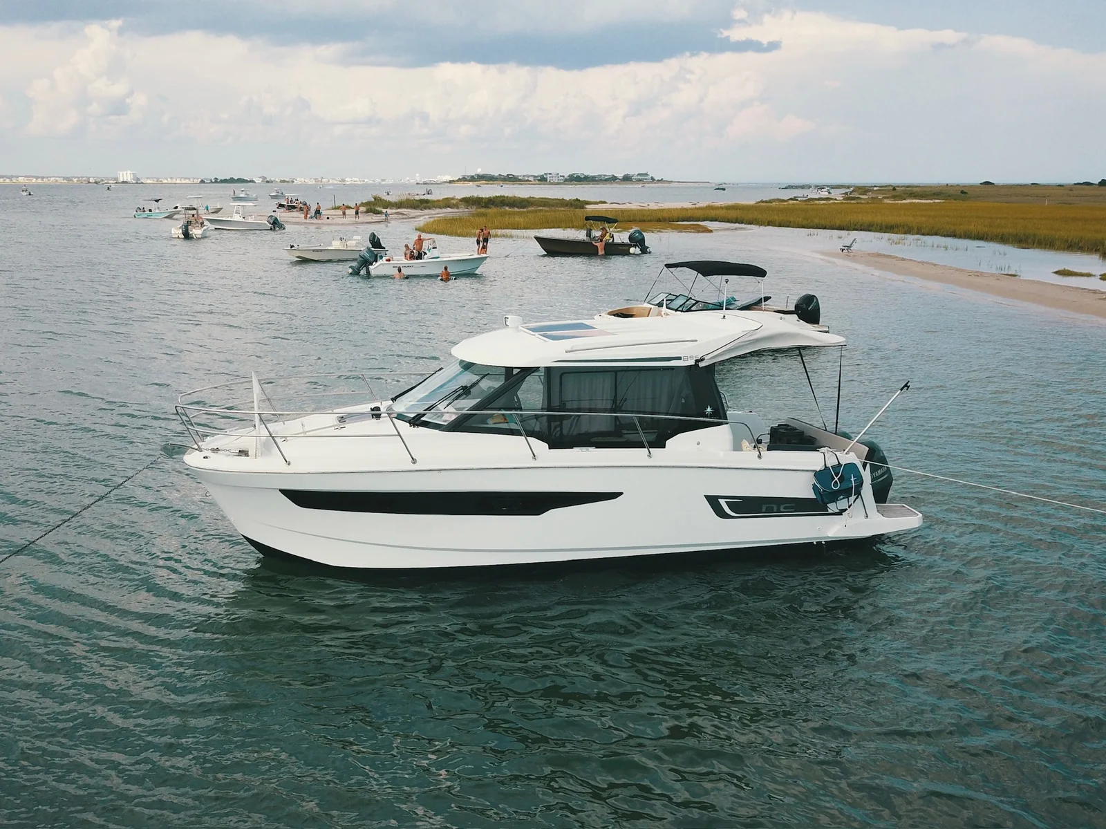 Port exterior profile of the 2018 Jeanneau NC 895 EZ Livin at anchor