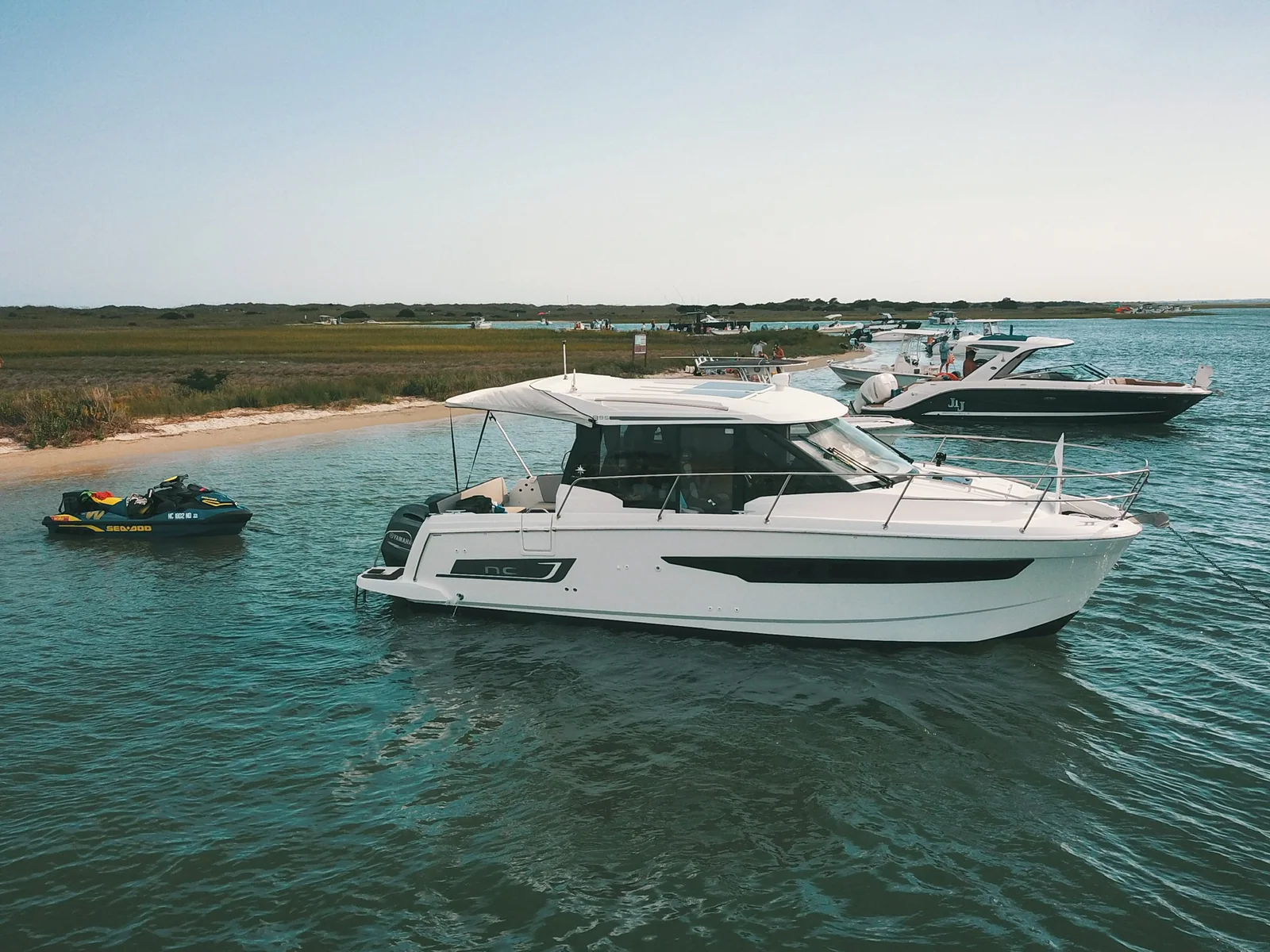 Starboard exterior profile of EZ Livin beside a sandy shoreline