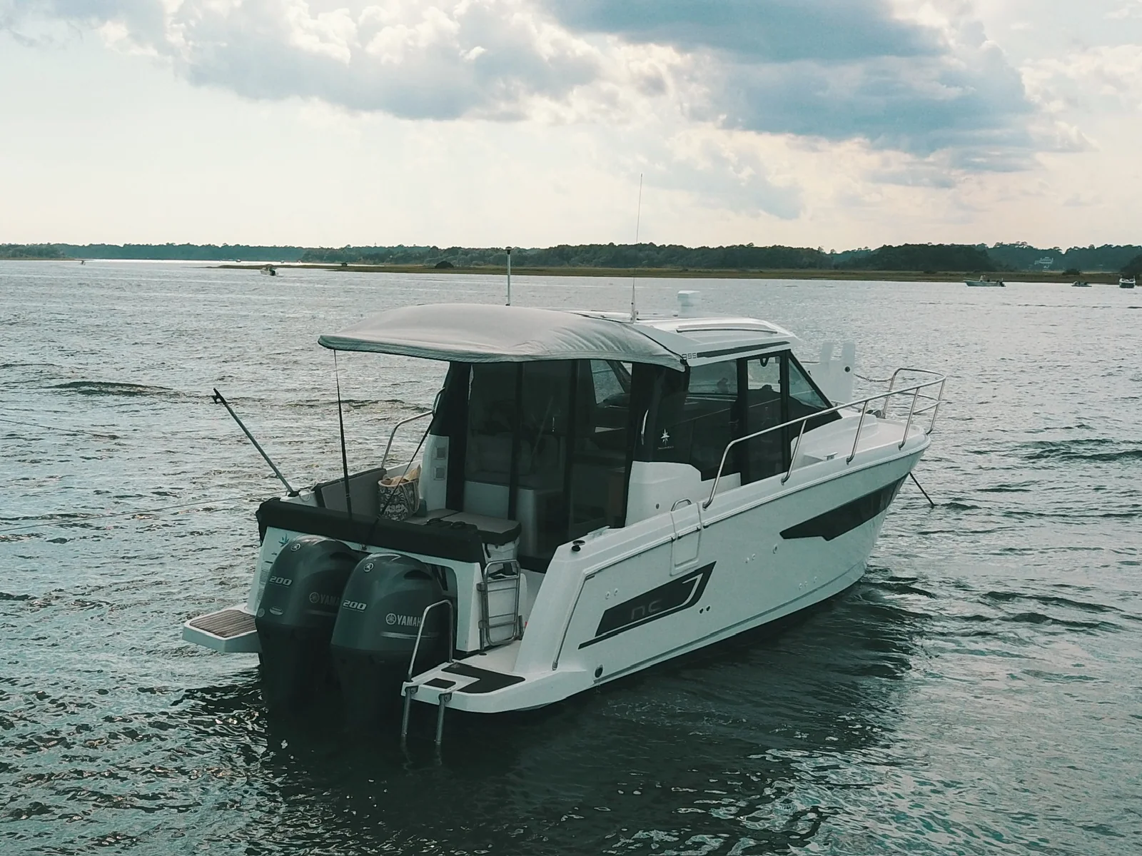Stern view of EZ Livin showing twin Yamaha 200 outboards, swim platforms and shaded cockpit